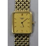 A gentleman's 9ct gold Longines Quartz wrist watch, on a 9ct Longines bracelet, with boxes.