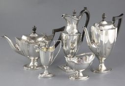 An Edwardian five piece silver vase shaped pedestal tea and coffee service and a plated tray, Thomas