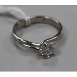 A modern 18ct white gold and twist claw set solitaire diamond ring, size M.