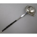 An 18ct century silver toddy ladle with baleen handle and bowl with inset coin, 31.7cm.