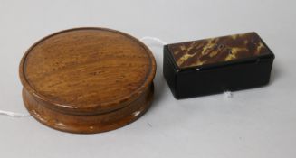 A circular turned oak snuff box and a rectangular lacquered snuff box, the oak example reputedly