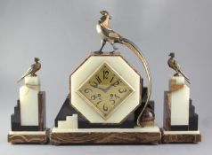 A 1930's onyx and hard stone mantel clock garniture, the octagonal case surmounted by a stylised
