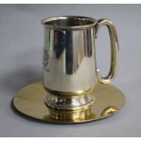 A George V silver christening mug and a silver gilt wafer dish.