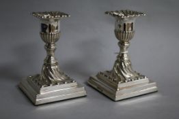 A pair of late Victorian silver dwarf candlesticks by Walker & Hall, Sheffield, 1898, weighted,