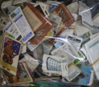 Assorted stamps and cigarette cards and tea cards