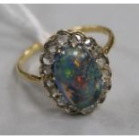 A yellow metal, opal and diamond oval cluster ring, size O.