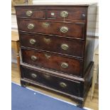 A George III oak chest on stand fitted two short drawers and four graduated long drawers, on bracket