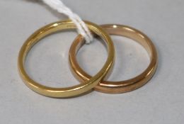 An 18ct gold wedding band and a 9ct gold wedding band.