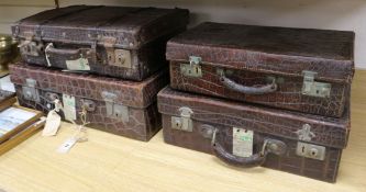 Four 1920's-30's crocodile suitcases Largest 55cm.