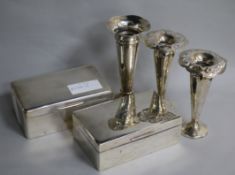 Two George V silver cigarette boxes and three vases.