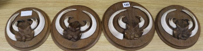 A set of four boar tusk panels diameter 24cm