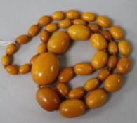 A single strand graduated oval amber bead necklace, gross weight 88 grams, 74cm.