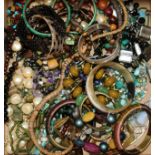 A quantity of assorted costume jewellery including bangles, necklaces etc.