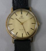 A gentleman's yellow metal Omega manual wind wrist watch.