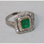 A white metal, emerald and diamond tablet cluster ring, size K.