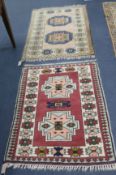 A red and cream ground rug and another 122 x 81cm, 108 x 78cm