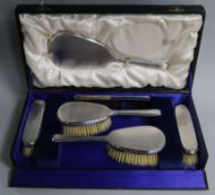 A cased 1940's silver six piece dressing table set, by William Comyns & Sons Ltd.