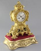 A mid 19th century French ormolu mantel clock and stand, the cartouche case raised on a giltwood