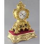 A mid 19th century French ormolu mantel clock and stand, the cartouche case raised on a giltwood