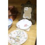 A brass framed mirror, a faience plate and a porcelain dish H.37cm