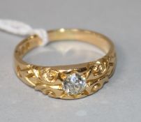 A gentleman's late Victorian 18ct gold and solitaire diamond ring, with carved shoulders, size Q.