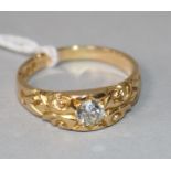 A gentleman's late Victorian 18ct gold and solitaire diamond ring, with carved shoulders, size Q.