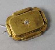 A yellow metal and diamond set brooch with glazed back, 39mm