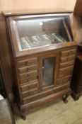 A 1920's walnut opticians's cabinet W.73cm