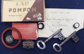 A group of curios including a cinnabar bangle, brooch, rings, keys etc