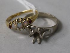 An early 20th century 18ct gold gem set ring (stones missing) and an 18ct white gold shank.