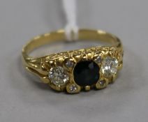 A 1970's 18ct gold, sapphire and diamond three stone ring, size M.