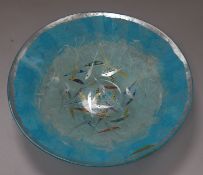 An Art Glass circular bowl by Margaret Johnson, decorated with multi-coloured fish on a pale blue