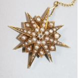 An Edwardian yellow metal, split pearl and diamond set starburst pendant brooch, 34mm.