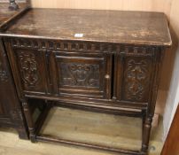 A carved oak cupboard W.91cm