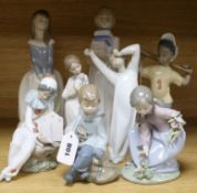 A collection of eight Lladro and Nao figures, including Girl with hat, Boy with books, Yawning