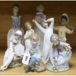 A collection of eight Lladro and Nao figures, including Girl with hat, Boy with books, Yawning