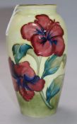 A Moorcroft Hibiscus pattern yellow ground baluster vase, impressed mark and painted green signature