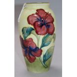 A Moorcroft Hibiscus pattern yellow ground baluster vase, impressed mark and painted green signature