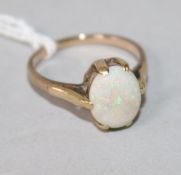 A yellow metal and white opal ring, size O.
