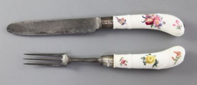 A Meissen porcelain handled knife and fork, c.1750, painted with floral sprays, ozier moulded