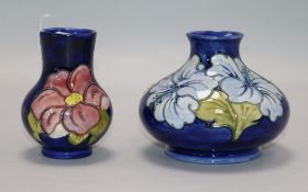 A Moorcroft Hibiscus pattern squat baluster vase, pale blue flowers on a cobalt ground and a small