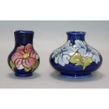 A Moorcroft Hibiscus pattern squat baluster vase, pale blue flowers on a cobalt ground and a small