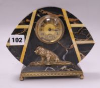 A black and amber art deco marble clock with bronze lion mount 15.5 x 19cm