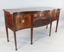 A George III crossbanded mahogany serpentine sideboard, with central drawer and tambour