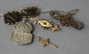 Two Victorian yellow metal mourning brooches , two bar brooches, an ARP badge and a cross pendant.
