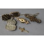 Two Victorian yellow metal mourning brooches , two bar brooches, an ARP badge and a cross pendant.