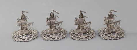 A set of four Edwardian novelty silver menu holders, modelled as galleons, by James Dudley,