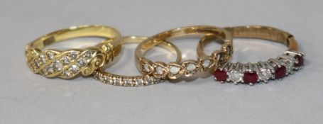 A ruby and diamond half-hoop ring, a diamond-set 18ct gold ring and two other rings.