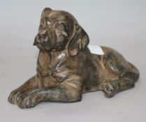 A bronzed model of a dog signed P Chenet 23cm.
