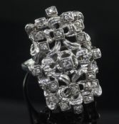 An 18ct white gold and diamond set modernist dress ring, of free form rectangular design, size V.